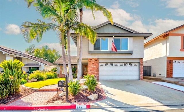 2771 Wyckersham Pl, Fullerton, CA 92833 - view of front of house with stucco siding, a garage, concrete driveway, and brick siding