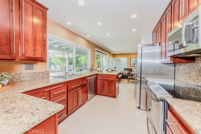 2771 Wyckersham Pl, Fullerton, CA 92833 - kitchen featuring stainless steel appliances, recessed lighting, light stone counters, tasteful backsplash, and open floor plan