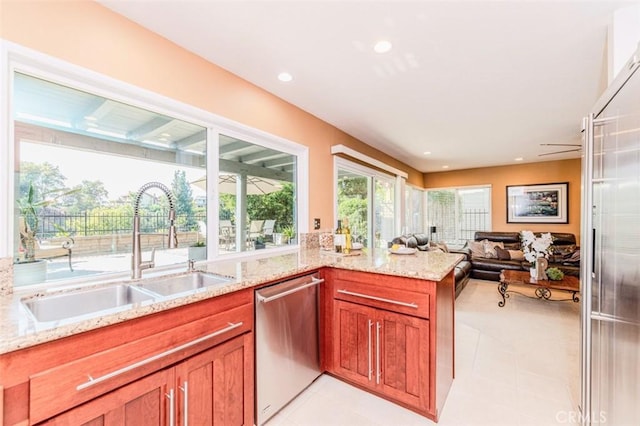 2771 Wyckersham Pl, Fullerton, CA 92833 - kitchen with stainless steel dishwasher, light tile patterned floors, light stone countertops, open floor plan, and recessed lighting