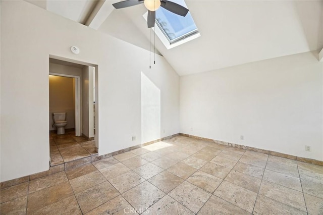 1263 Pismo St, San Luis Obispo, CA 93401 - empty room with a skylight, ceiling fan, stone tile floors, high vaulted ceiling, and a smoke detector