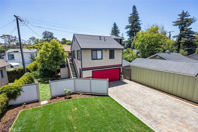 1263 Pismo St, San Luis Obispo, CA 93401 - back of house featuring stairs, decorative driveway, an attached garage, and a shingled roof
