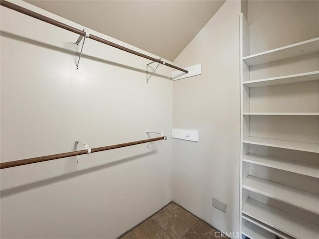 1263 Pismo St, San Luis Obispo, CA 93401 - spacious closet featuring vaulted ceiling and tile patterned floors