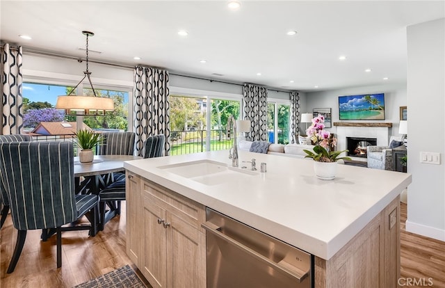 5490 Paseo Del Lago W Unit P, Laguna Woods, CA 92637 - kitchen with dishwasher, light brown cabinetry, light wood-style flooring, a lit fireplace, and open floor plan