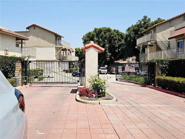 874 Cinnamon Ln Unit 62, Duarte, CA 91010 - view of road featuring a gate, a gated entry, and curbs