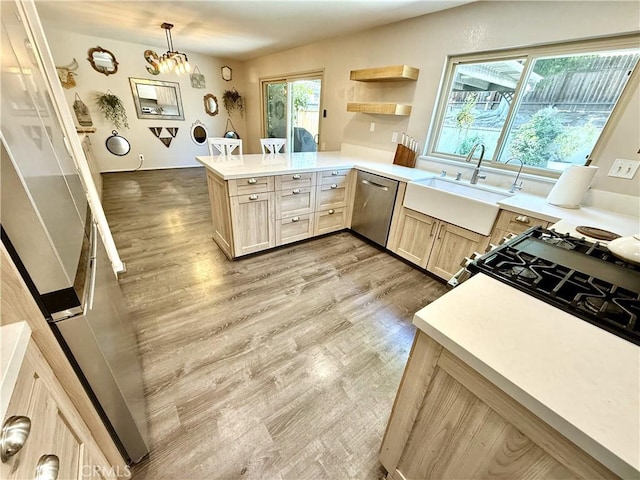 1171 Silverfern Ln, Corona, CA 92878 - kitchen featuring stainless steel dishwasher, light brown cabinetry, a peninsula, light wood-type flooring, and light countertops