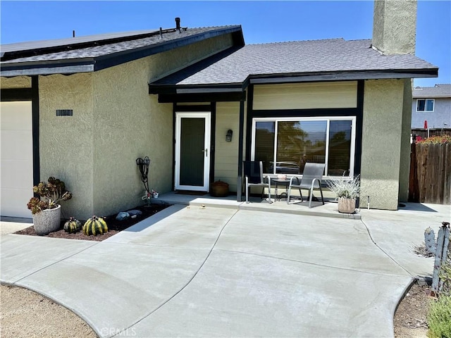 1171 Silverfern Ln, Corona, CA 92878 - back of house with a shingled roof, a chimney, stucco siding, and covered porch