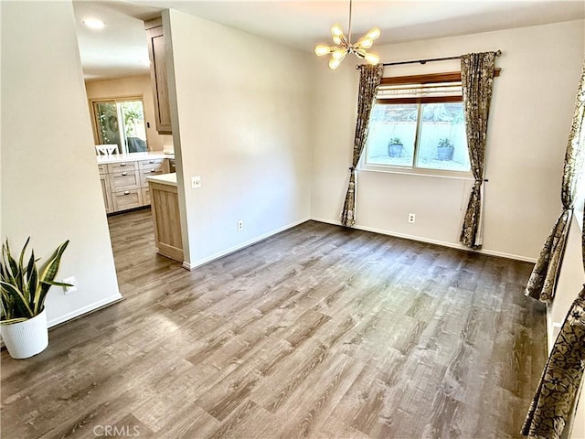1171 Silverfern Ln, Corona, CA 92878 - spare room with a chandelier and wood finished floors