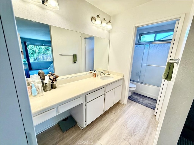 1171 Silverfern Ln, Corona, CA 92878 - full bathroom with vanity, wood finished floors, plenty of natural light, and combined bath / shower with glass door