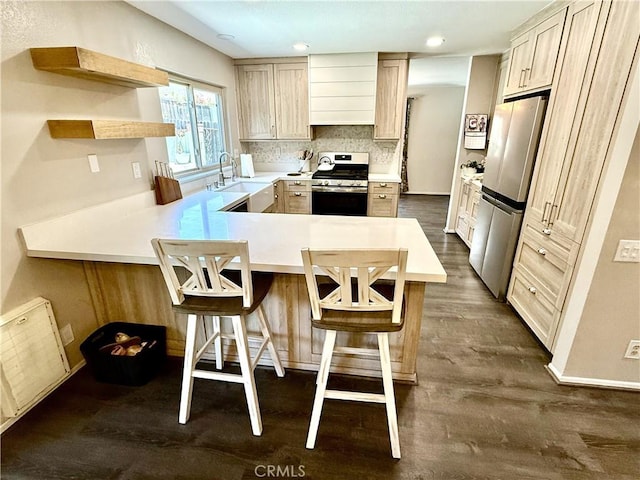 1171 Silverfern Ln, Corona, CA 92878 - kitchen with appliances with stainless steel finishes, a peninsula, light countertops, dark wood-type flooring, and a breakfast bar