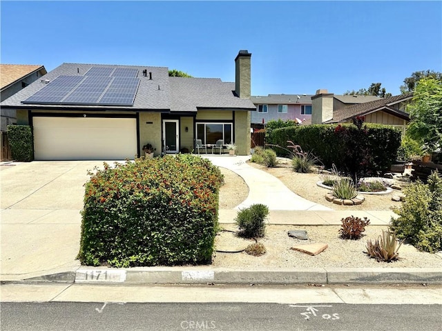 1171 Silverfern Ln, Corona, CA 92878 - ranch-style home featuring solar panels, a chimney, a garage, and driveway