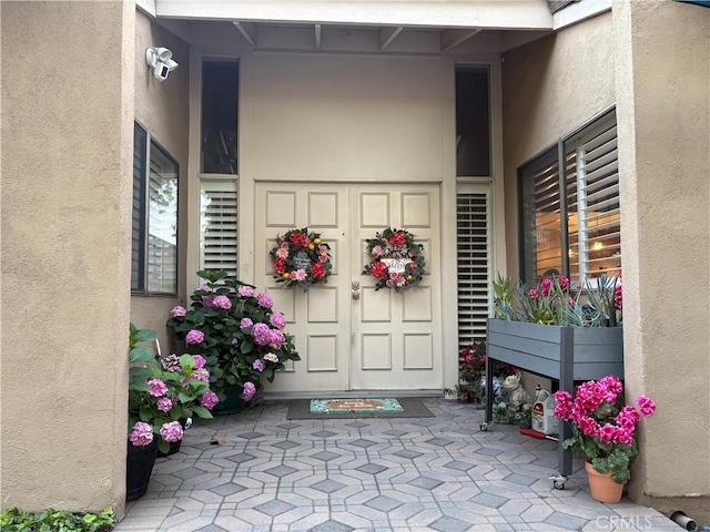 1137 Mountain Gate Rd, Upland, CA 91786 - view of exterior entry featuring stucco siding and a surveillance system