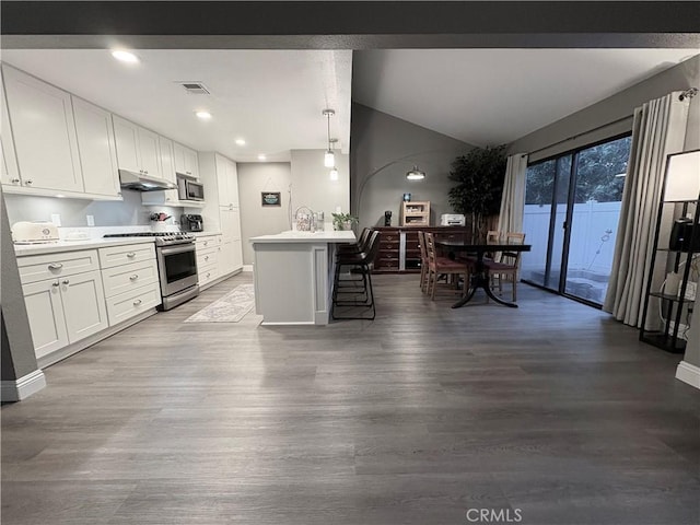 1137 Mountain Gate Rd, Upland, CA 91786 - kitchen featuring appliances with stainless steel finishes, lofted ceiling, wood finished floors, white cabinets, and light countertops