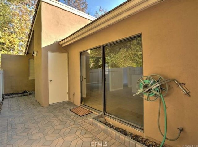 1137 Mountain Gate Rd, Upland, CA 91786 - property entrance featuring stucco siding and a patio