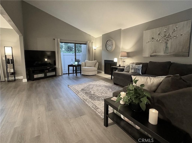 1137 Mountain Gate Rd, Upland, CA 91786 - living room featuring high vaulted ceiling, wood finished floors, and a fireplace
