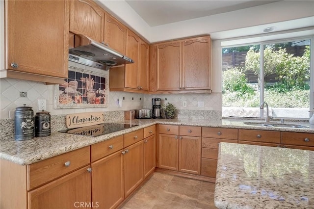 53 Via Palacio, San Clemente, CA 92673 - kitchen with extractor fan, light stone countertops, black electric stovetop, and backsplash