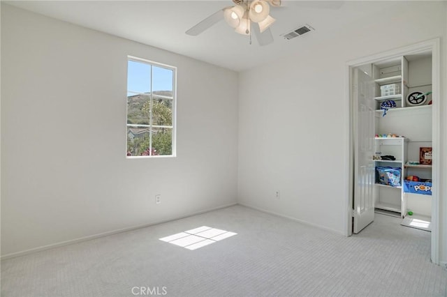 53 Via Palacio, San Clemente, CA 92673 - unfurnished bedroom featuring carpet floors, a walk in closet, a closet, and a ceiling fan