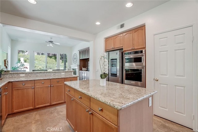 53 Via Palacio, San Clemente, CA 92673 - kitchen featuring stainless steel appliances, light stone countertops, a center island, recessed lighting, and ceiling fan