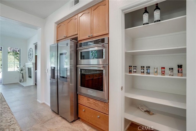 53 Via Palacio, San Clemente, CA 92673 - kitchen featuring appliances with stainless steel finishes, light tile patterned floors, and light stone countertops