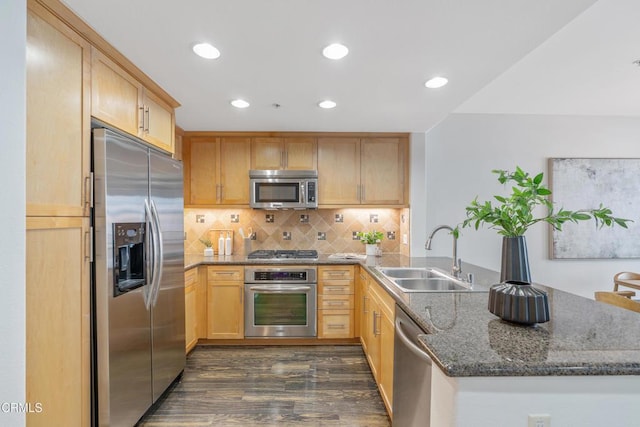 931 E Walnut St Unit 508, Pasadena, CA 91106 - kitchen featuring appliances with stainless steel finishes, a peninsula, dark wood-style floors, dark stone counters, and recessed lighting