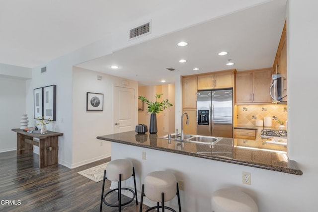 931 E Walnut St Unit 508, Pasadena, CA 91106 - kitchen featuring stainless steel appliances, a peninsula, dark stone counters, tasteful backsplash, and recessed lighting