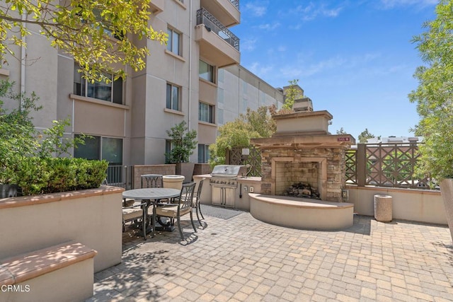 931 E Walnut St Unit 508, Pasadena, CA 91106 - view of patio / terrace with an outdoor stone fireplace, a grill, and outdoor dining area