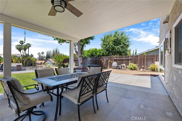 6095 Windemere Way, Riverside, CA 92506 - fenced backyard with a patio, outdoor dining area, and ceiling fan