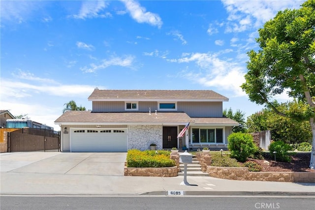 6095 Windemere Way, Riverside, CA 92506 - traditional-style home featuring driveway, a gate, an attached garage, a tile roof, and stone siding