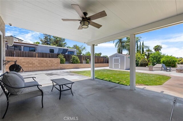 6095 Windemere Way, Riverside, CA 92506 - fenced backyard featuring a patio, a storage unit, and ceiling fan