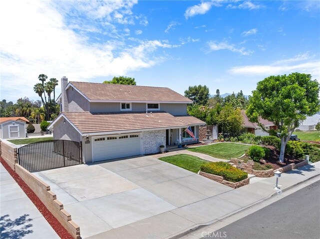 6095 Windemere Way, Riverside, CA 92506 - traditional home featuring a tile roof, a garage, driveway, stone siding, and a gate