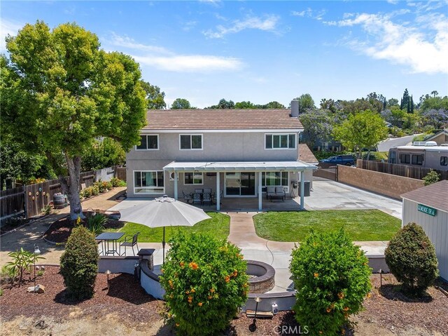 6095 Windemere Way, Riverside, CA 92506 - back of property featuring a patio area, a fenced backyard, a chimney, and stucco siding