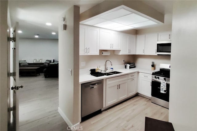 1034 Occidental Cir, Redlands, CA 92374 - kitchen with stainless steel appliances, white cabinetry, light wood-style flooring, light countertops, and recessed lighting