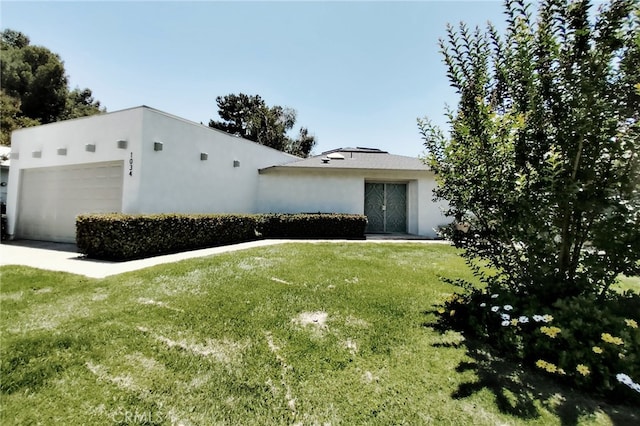 1034 Occidental Cir, Redlands, CA 92374 - view of front of house featuring a front yard, stucco siding, and a garage