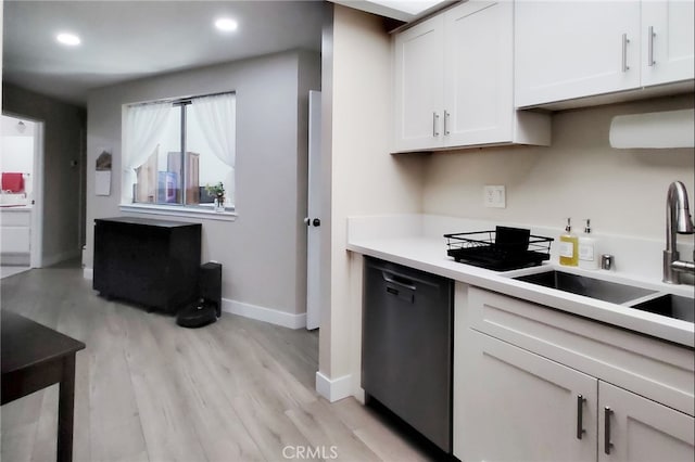 1034 Occidental Cir, Redlands, CA 92374 - kitchen with dishwashing machine, light wood finished floors, white cabinetry, light countertops, and recessed lighting