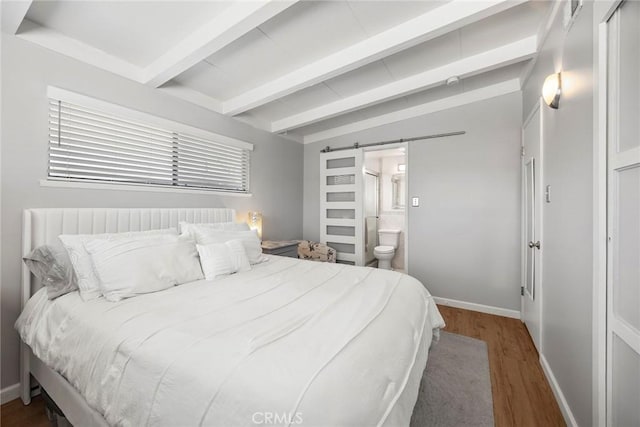 18101 Kirk Ave, Tustin, CA 92780 - bedroom featuring wood finished floors, a barn door, ensuite bath, and multiple windows