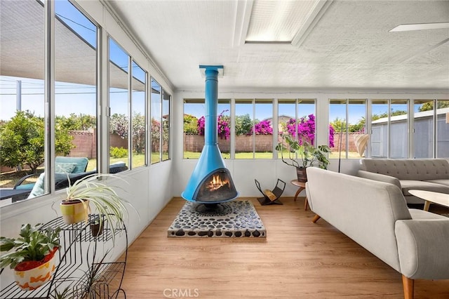 18101 Kirk Ave, Tustin, CA 92780 - sunroom / solarium with plenty of natural light, a wood stove, and wood finished floors
