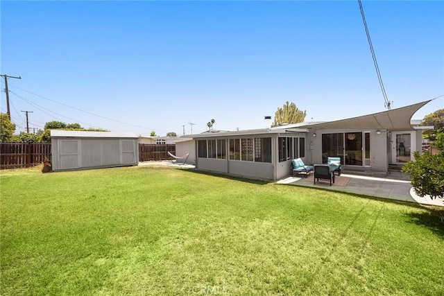 18101 Kirk Ave, Tustin, CA 92780 - back of property with a fenced backyard, a sunroom, a storage unit, and a patio area