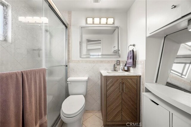 18101 Kirk Ave, Tustin, CA 92780 - full bath featuring tile walls, vanity, a stall shower, and tile patterned floors