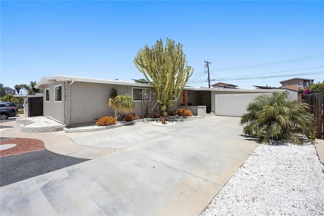 18101 Kirk Ave, Tustin, CA 92780 - view of front of home featuring stucco siding, a garage, and concrete driveway