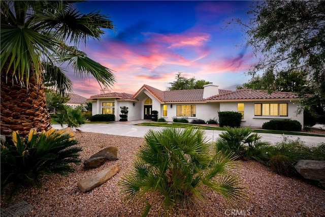 41901 Calle Clarita, Lancaster, CA 93536 - view of front of home featuring stucco siding, a chimney, and concrete driveway