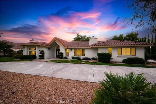 41901 Calle Clarita, Lancaster, CA 93536 - view of front facade featuring a chimney, stucco siding, and a tiled roof