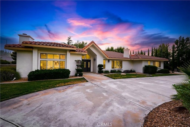 41901 Calle Clarita, Lancaster, CA 93536 - view of front of property with a chimney, french doors, stucco siding, a tile roof, and a front yard