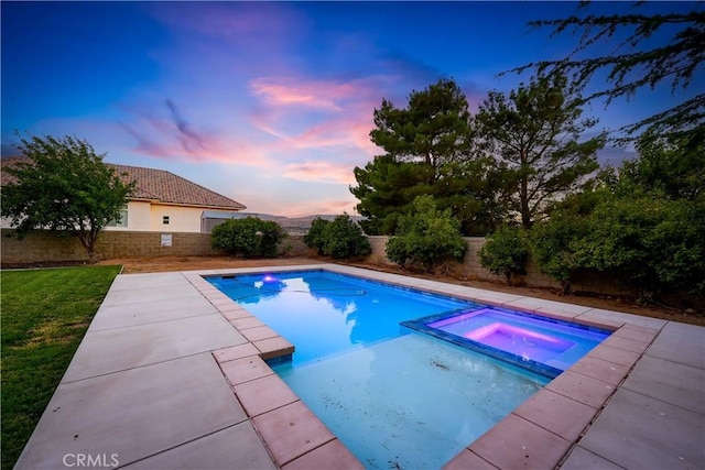 41901 Calle Clarita, Lancaster, CA 93536 - pool at dusk with a fenced backyard, a pool with connected hot tub, and a patio area