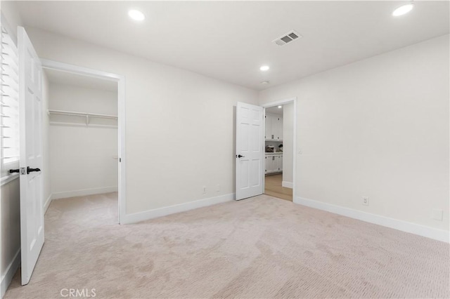 41901 Calle Clarita, Lancaster, CA 93536 - unfurnished bedroom featuring light carpet, recessed lighting, a spacious closet, and a closet
