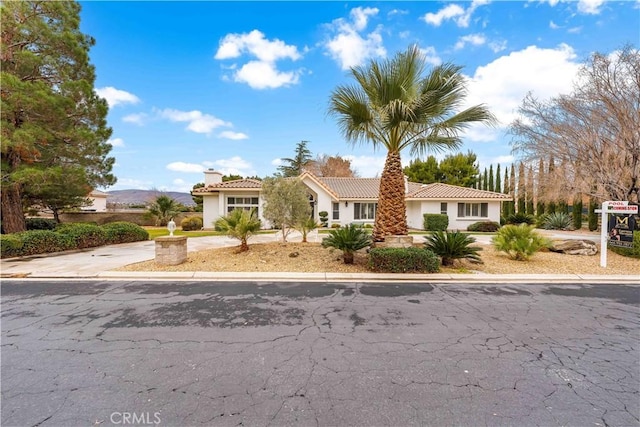 41901 Calle Clarita, Lancaster, CA 93536 - view of front of property featuring a chimney, stucco siding, and a tiled roof