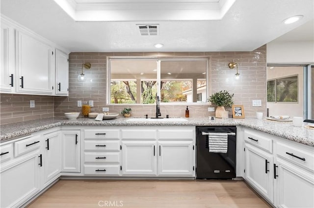 41901 Calle Clarita, Lancaster, CA 93536 - kitchen with black dishwasher, a raised ceiling, light wood finished floors, backsplash, and white cabinetry