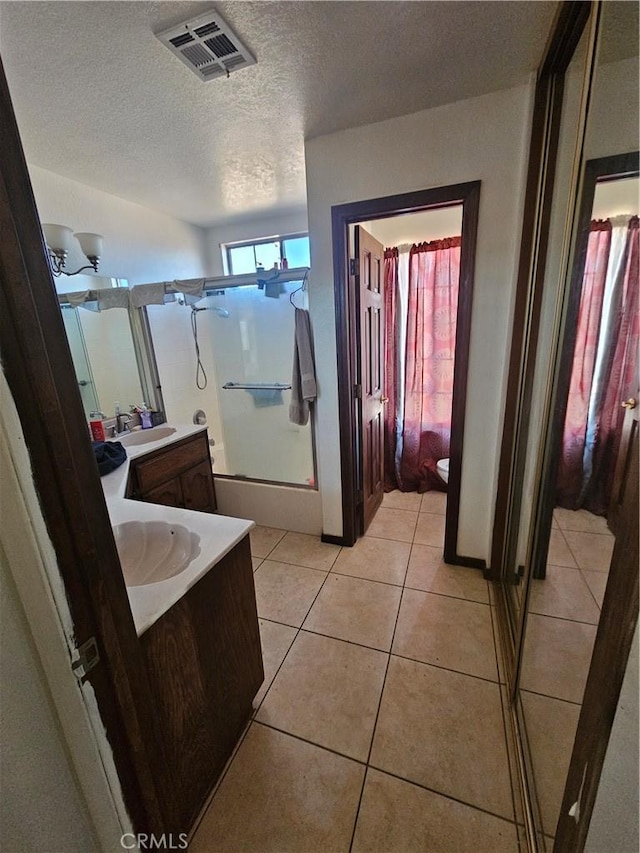 16709 Deodar St, Hesperia, CA 92345 - full bath with a shower stall, vanity, tile patterned flooring, and a textured ceiling