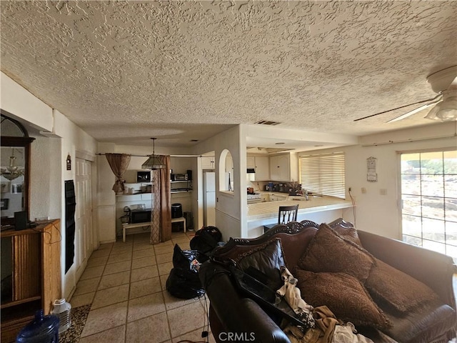 16709 Deodar St, Hesperia, CA 92345 - living room featuring a textured ceiling, a ceiling fan, and light tile patterned floors