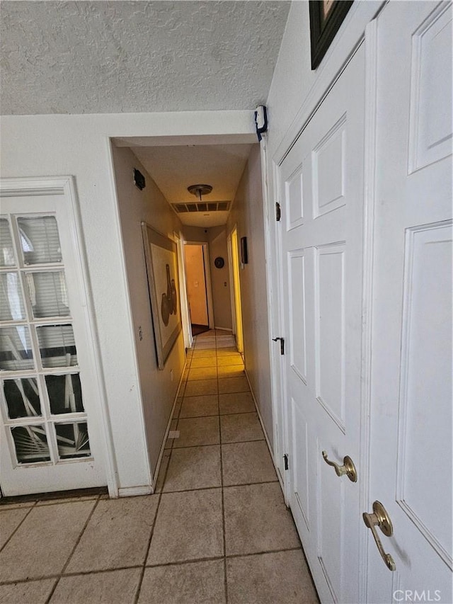 16709 Deodar St, Hesperia, CA 92345 - corridor with light tile patterned flooring and a textured ceiling