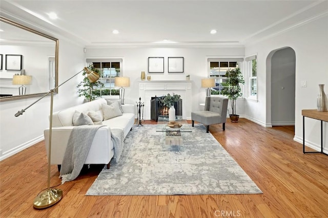 3326 Los Olivos Ln, Glendale, CA 91214 - living area with arched walkways, a fireplace with flush hearth, wood finished floors, ornamental molding, and recessed lighting