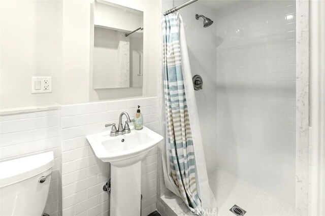 3326 Los Olivos Ln, Glendale, CA 91214 - bathroom featuring tile walls, a shower stall, and wainscoting